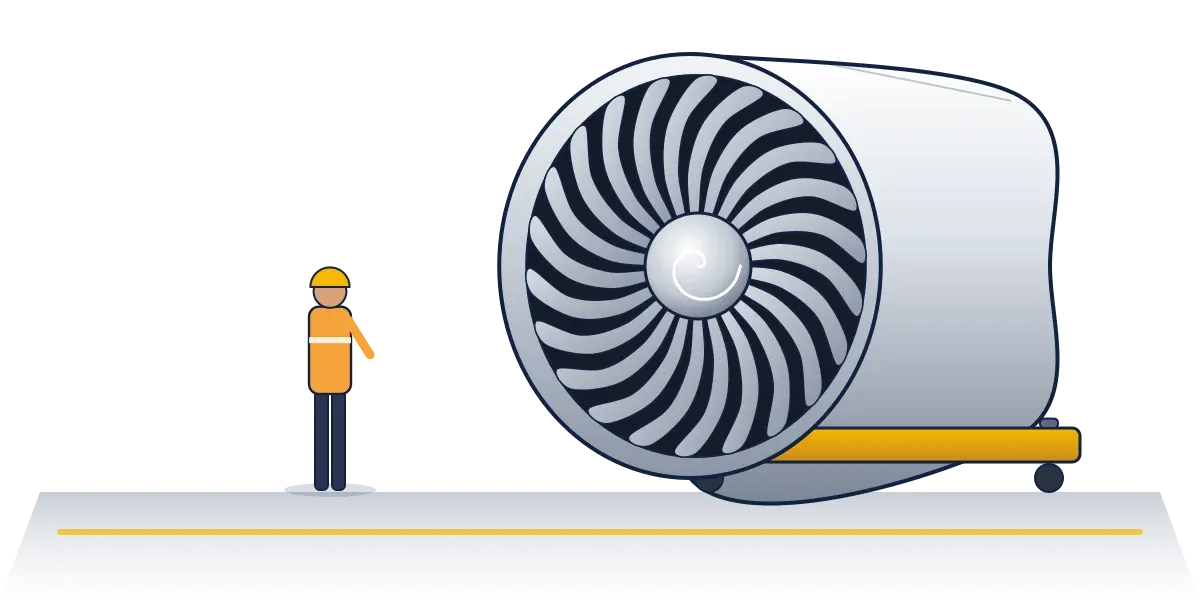 A worker in a hard hat and high-visibility vest standing beside a turbofan engine on a trolley, dwarfed by its fan